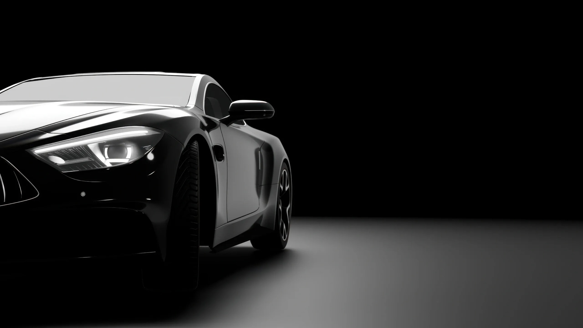 Close-up of a black luxury sports car's front end and headlight