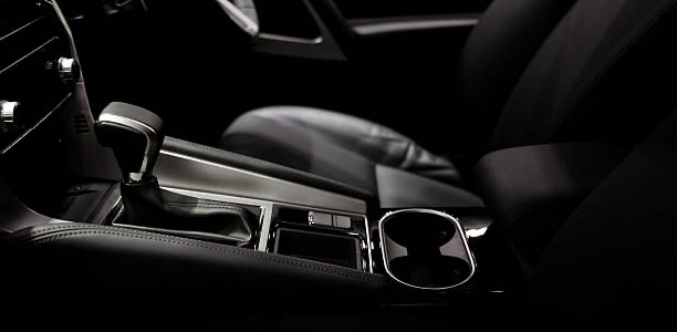 Close-up of a car's premium dark leather interior, center console and gearshift